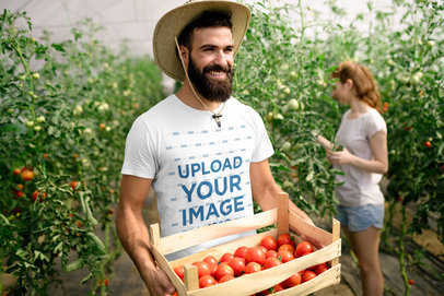 Mockup of a Man Wearing a Crew-Neck T-Shirt and Carrying a Tomato Box