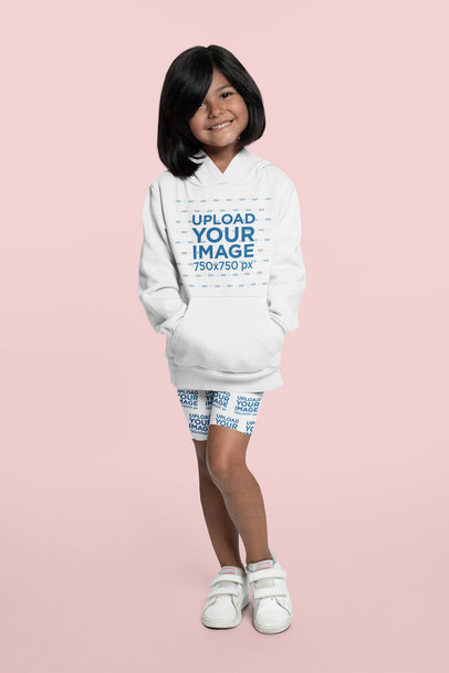 Mockup of a Little Girl Wearing a Hoodie and Bike Shorts