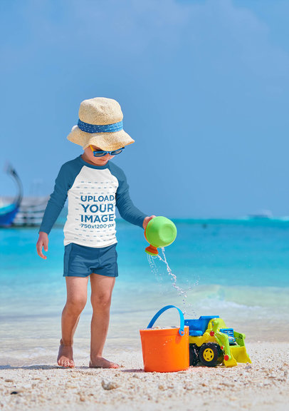 Mockup of a Little Boy with a Raglan Long-Sleeve Tee Playing in the Sand