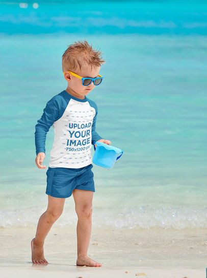 Mockup of a Little Boy Wearing a Raglan Long-Sleeve Tee on the Beach