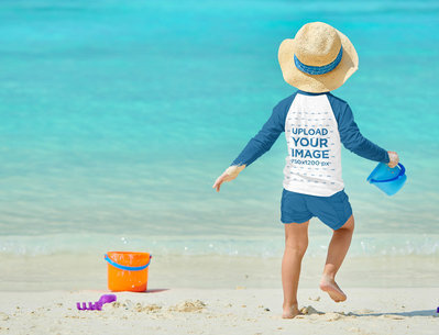 Mockup Featuring a Boy with a Raglan Long-Sleeve Tee Playing at the Beach
