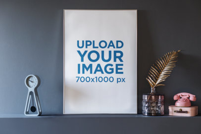 Mockup Featuring an Art Print Placed on a Shelf Next to a Small Clock 