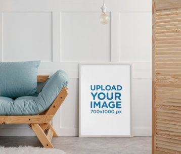 Mockup of an Art Print Placed on the Floor by a Wooden Sofa