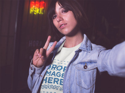 Selfie Mockup of a Hispanic Woman Wearing a Round Neck Tshirt While Outside a Closed Japanse Food Restaurant