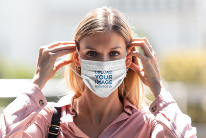 Mockup of a Blonde Woman Putting on a Face Mask