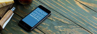 Mockup of an iPhone 5s in Space Grey over a Wooden Surface