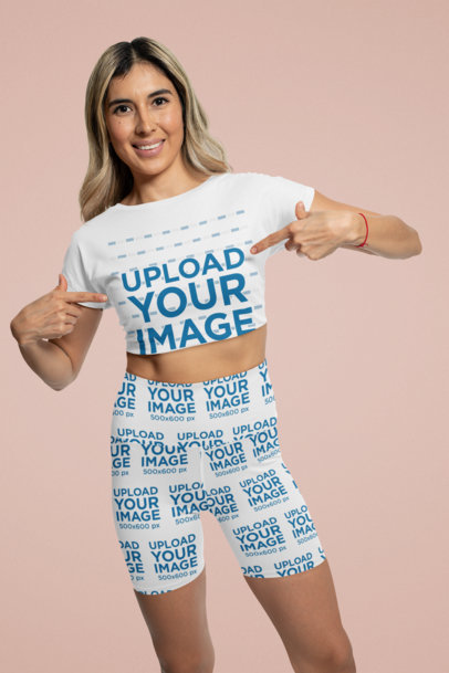 Mockup of a Woman Wearing Bike Shorts and Pointing at Her Crop Top 42342