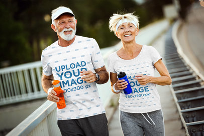 T-Shirt Mockup of a Senior Man and a Woman Running on a Sidewalk 