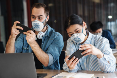 Face Mask Mockup of a Man and a Woman Playing Mobile Games