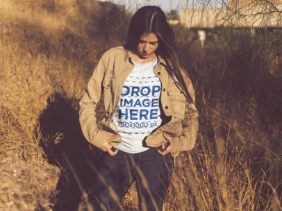 Template of a Young Woman with Long Hair Wearing a Round Neck Camping T-Shirt While Standing Outdoors