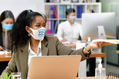 Face Mask Mockup of a Woman Working in an Office