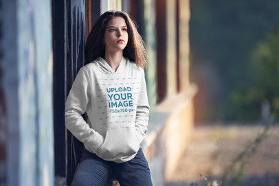 Mockup of a Serious Woman Wearing a Customizable Pullover Hoodie 