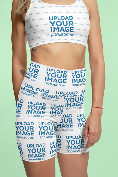 Mockup of a Woman Wearing Sports Bra and Biking Shorts in a Studio