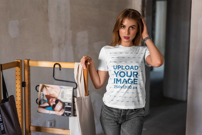 T-Shirt Mockup Featuring a Young Woman Posing in an Atelier 