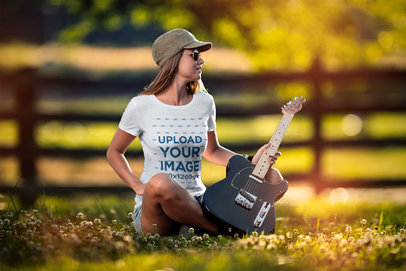 T-Shirt Mockup Featuring a Woman Holding an Electric Guitar 