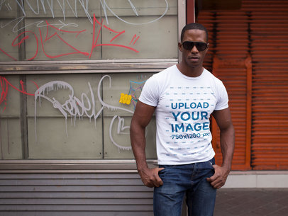 Mockup of a Man Wearing a Round Neck T-Shirt and Sunglasses While at the City