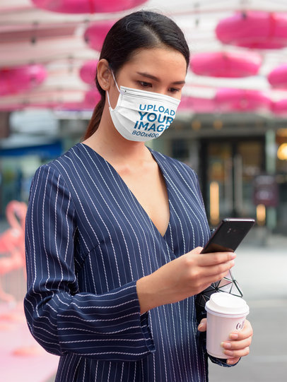 Face Mask Mockup Featuring a Serious Woman Checking Her Phone 