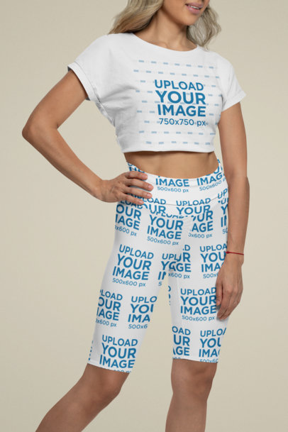 Mockup of a Woman Wearing a Crop Top and Bike Shorts in a Studio