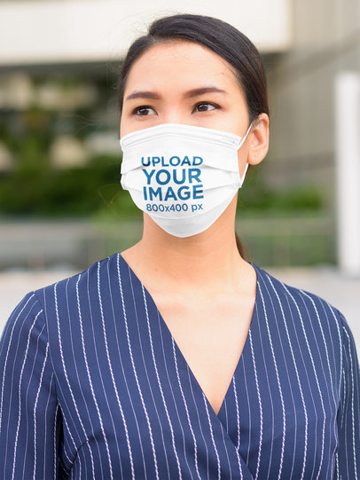 Face Mask Mockup of a Serious Woman Standing on the Street