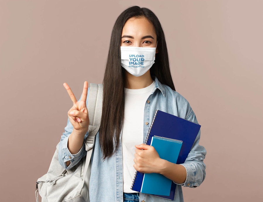 Face Mask Mockup of a College Student Posing in a Studio