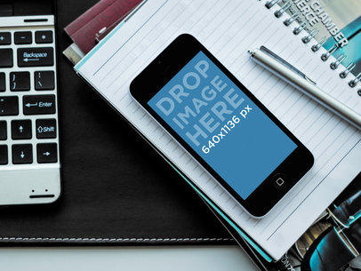 iPhone 5C Mockup Featuring an Office Environment