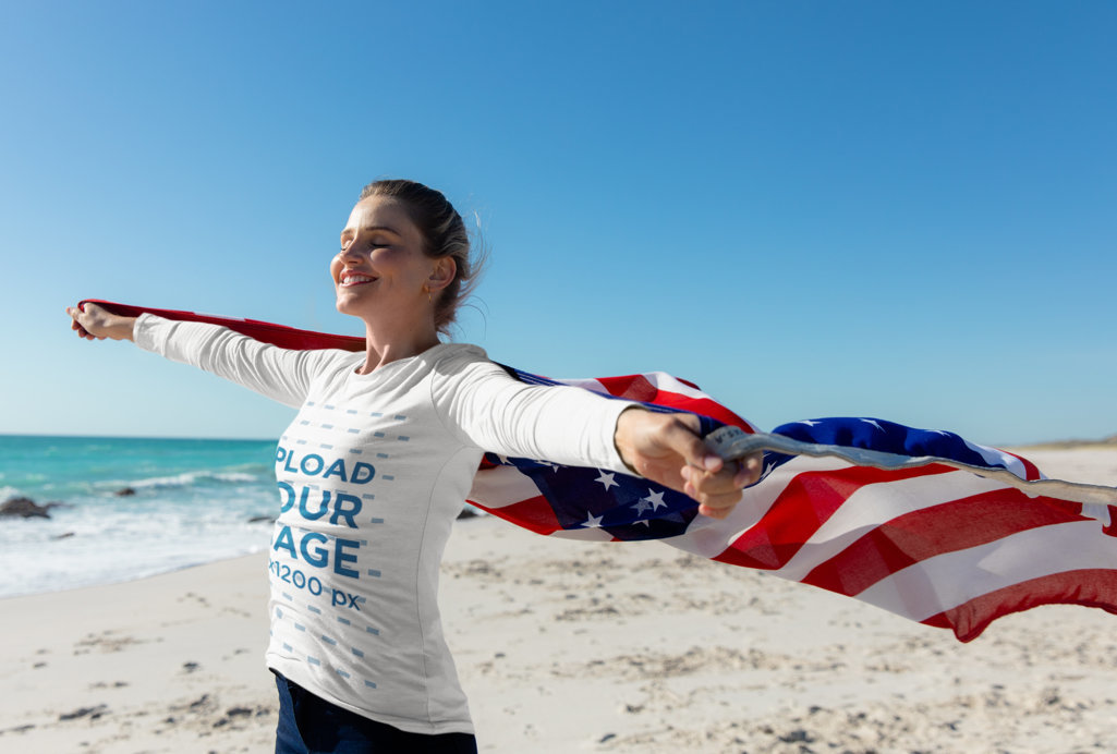 Long Sleeve Tee Mockup of a Woman Holding the US Flag at the Beach