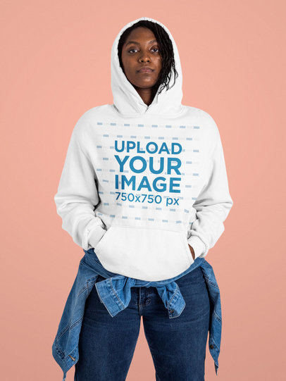 Hoodie Mockup Featuring a Though-Looking Woman Standing at a Studio