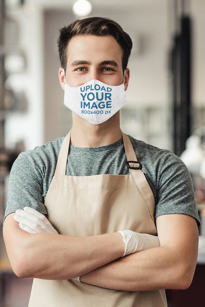 Face Mask Mockup Featuring a Worker With His Arms Crossed