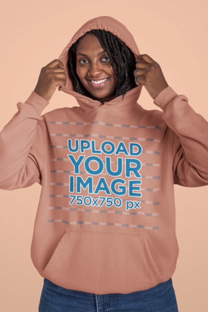 Mockup of a Woman Putting on a Hoodie at a Studio