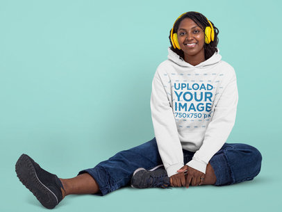 Hoodie Mockup Featuring a Happy Woman Listening to Music at a Studio 
