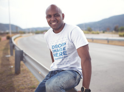 Mockup of a Happy Bald Guy Wearing a Round Neck T-Shirt in the Country Road