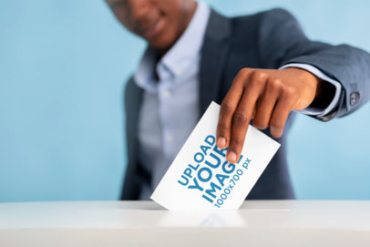 Mockup of a Man in a Suit Placing a Horizontal Flyer into a Voting Box