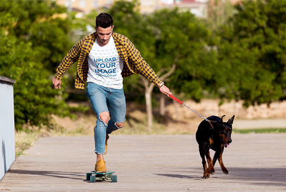 T-Shirt Mockup of a Young Skater Taking His Dog for a Walk