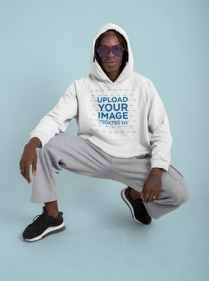 Pullover Hoodie Mockup of a Man With Purple Sunglasses Posing at a Studio
