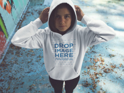 Young Woman Wearing a Pullover Hoodie While Standing in an Abandoned Pool Mockup