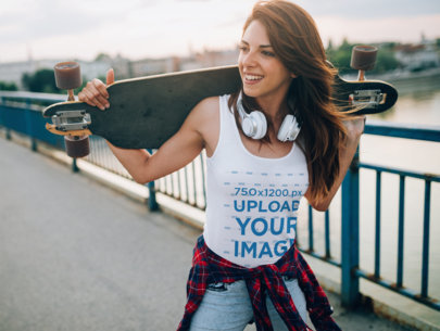 Tank Top Mockup of a Woman Carrying a Longboard on the Street
