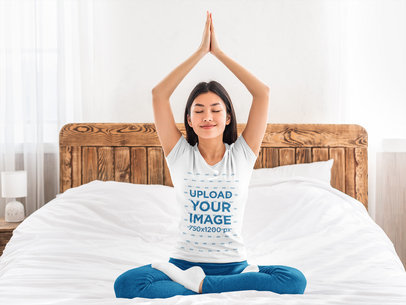 T-Shirt Mockup of a Woman Doing Yoga on Her Bed