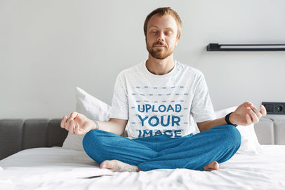 T-Shirt Mockup of a Man Sitting on His Bed Meditating
