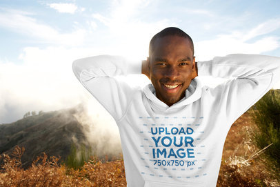 Pullover Hoodie Mockup Featuring a Man Against a Nature Landscape 