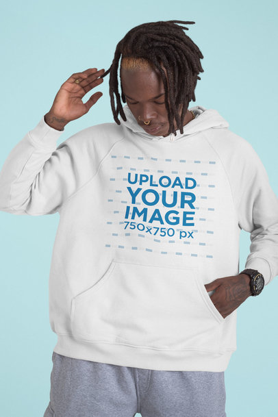 Hoodie Mockup Featuring a Man With a Hand Tattoo at a Studio 