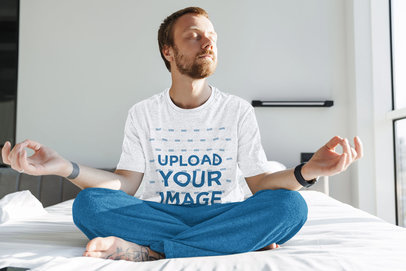 T-Shirt Mockup of a Man Meditating on His Bed