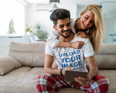 T-Shirt Mockup of a Young Man with His Girlfriend at Home