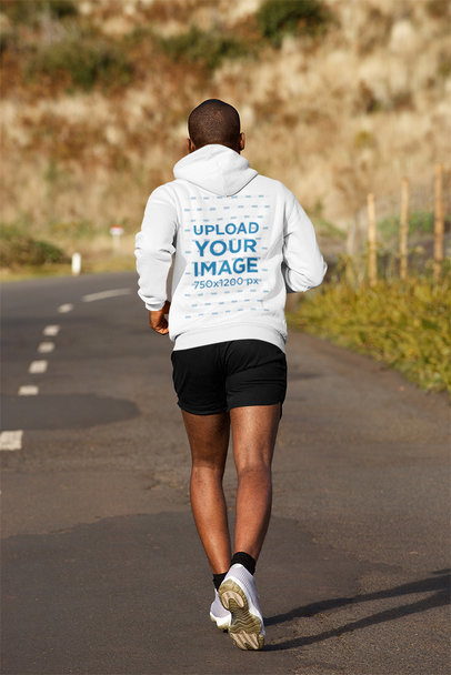 Back-View Mockup of a Man Wearing a Hoodie While Running