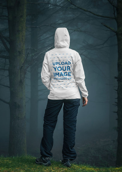 Back-View Hoodie Mockup of a Woman in a Rainy Forest
