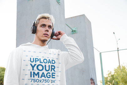 Hoodie Mockup Featuring a Serious Man With Headphones 