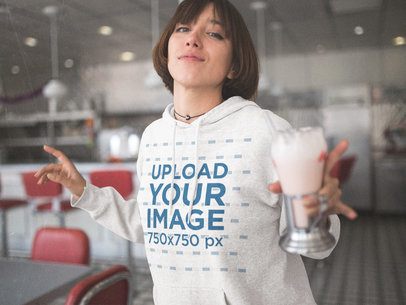 Template of a Young Woman Dancing While Holding a Milkshake Wearing a Pullover Hoodie