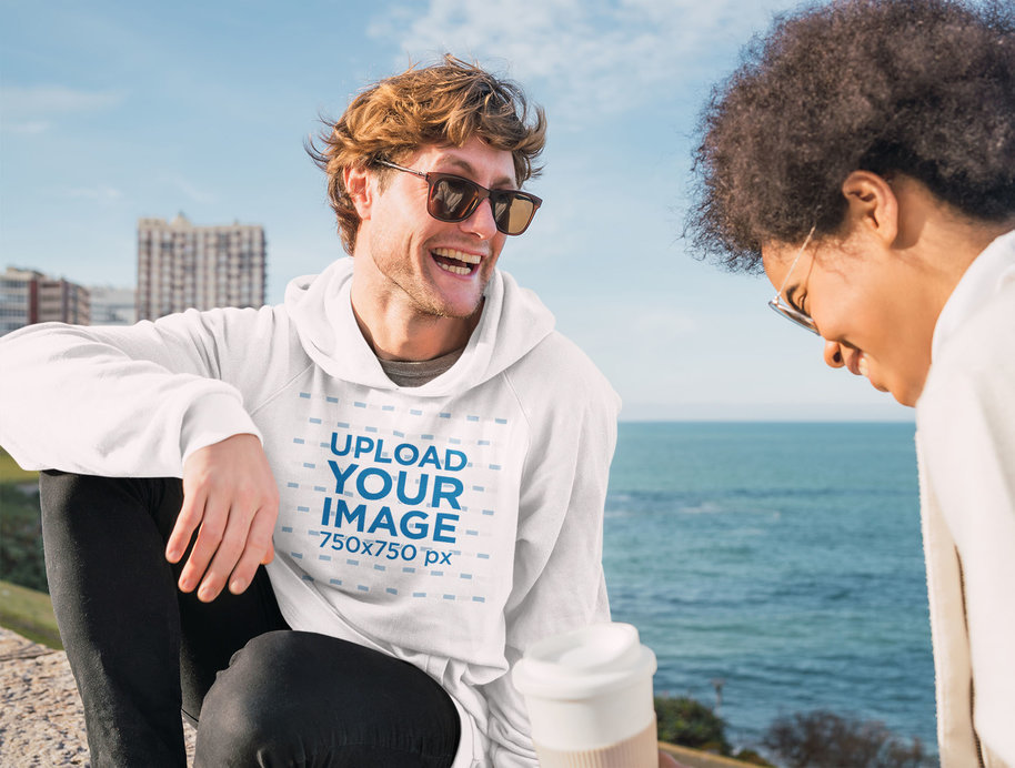 Pullover Hoodie Mockup of a Man at the Beach Talking with a Friend