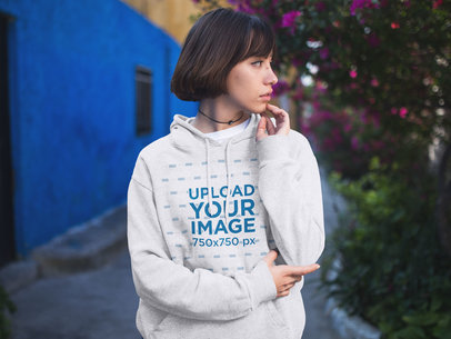Young Trendy Woman Looking Away While Wearing a Pullover Hoodie in the Street Mockup