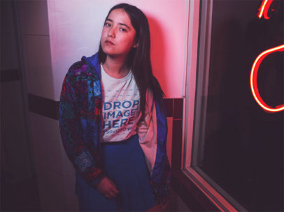 Mockup of a Girl Wearing a T-Shirt With Blue Clothes on Top of It While Near a Red Light a13590