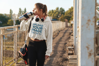 Crop Top Hoodie Mockup of a Woman in an Urban Setting